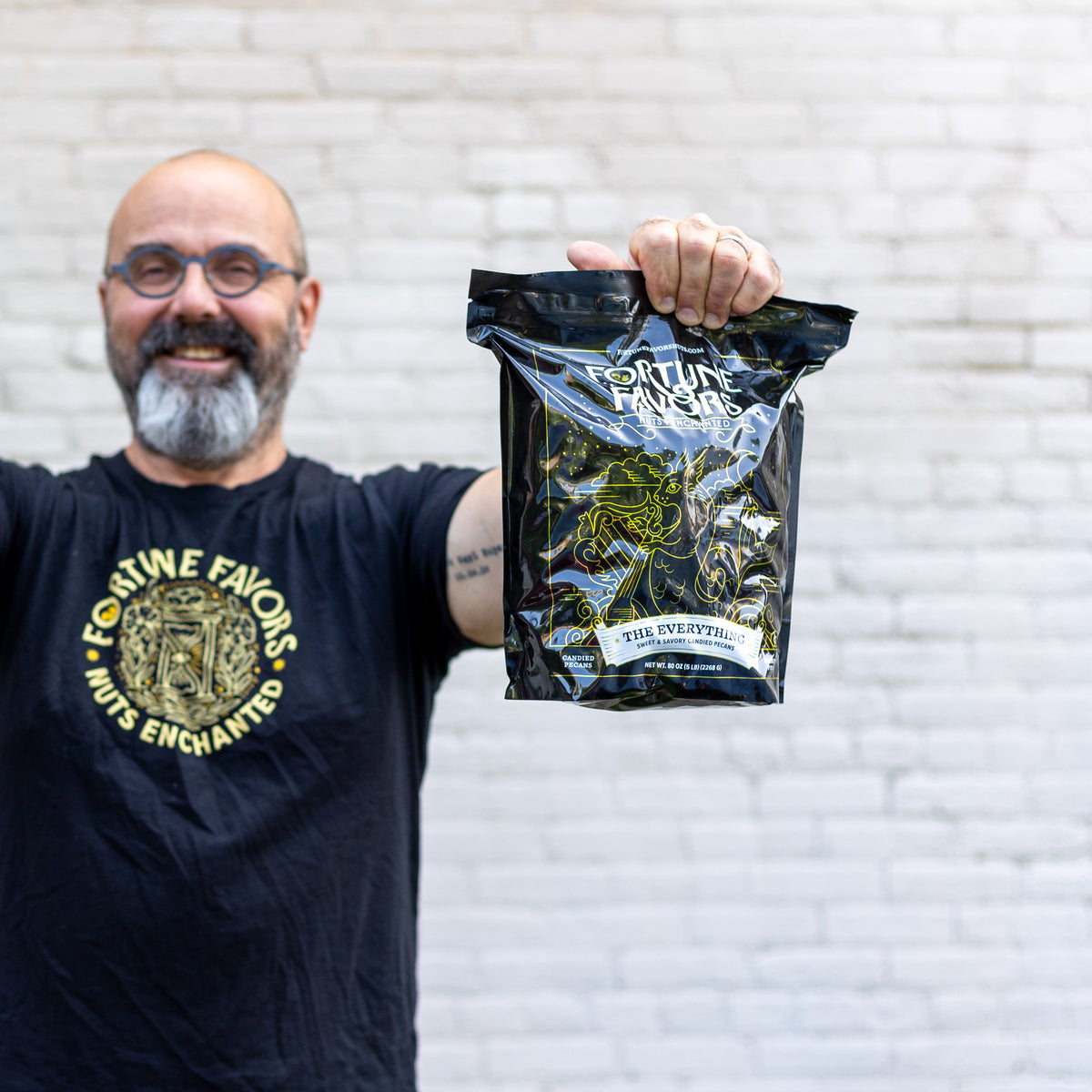 Eric of FF holding 5lb bag of Fortune Favors The Everything