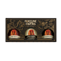 Black and gold sampler gift pack containing three 16 ounce cans of Fortune Favors candied pecans, one of each signature flavor.