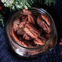 dish of Fortune Favors Sweater Weather spiced and sweet candied pecans with holiday decorations