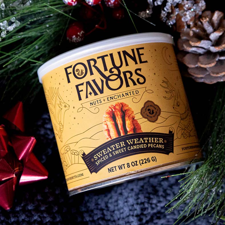 can of Fortune Favors Sweater Weather spiced and sweet candied pecans with holiday decorations